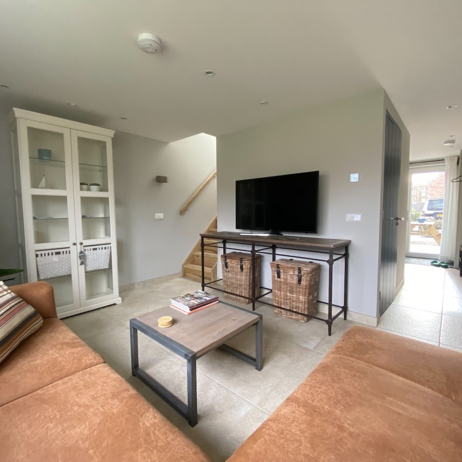 Vakantiewoning Westkaap woonkamer met loungebank en TV